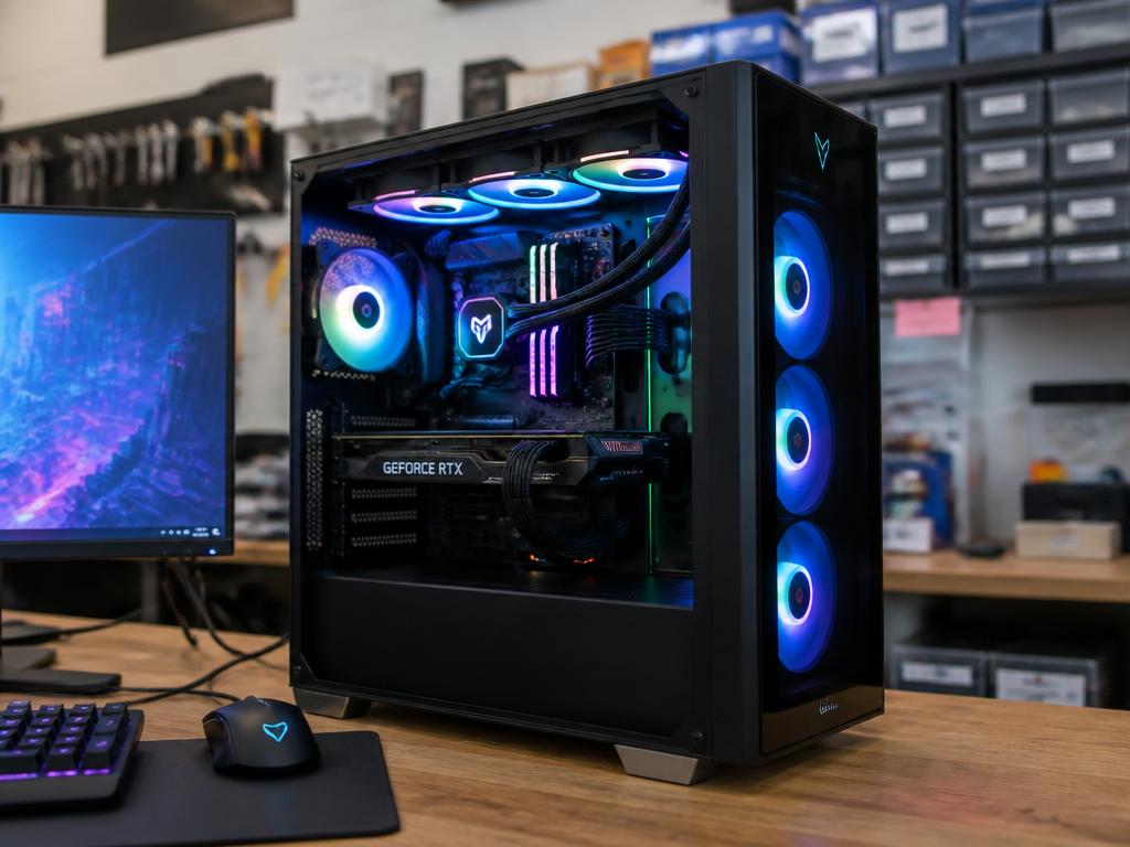 A custom-built gaming PC on the workbench with RGB lighting